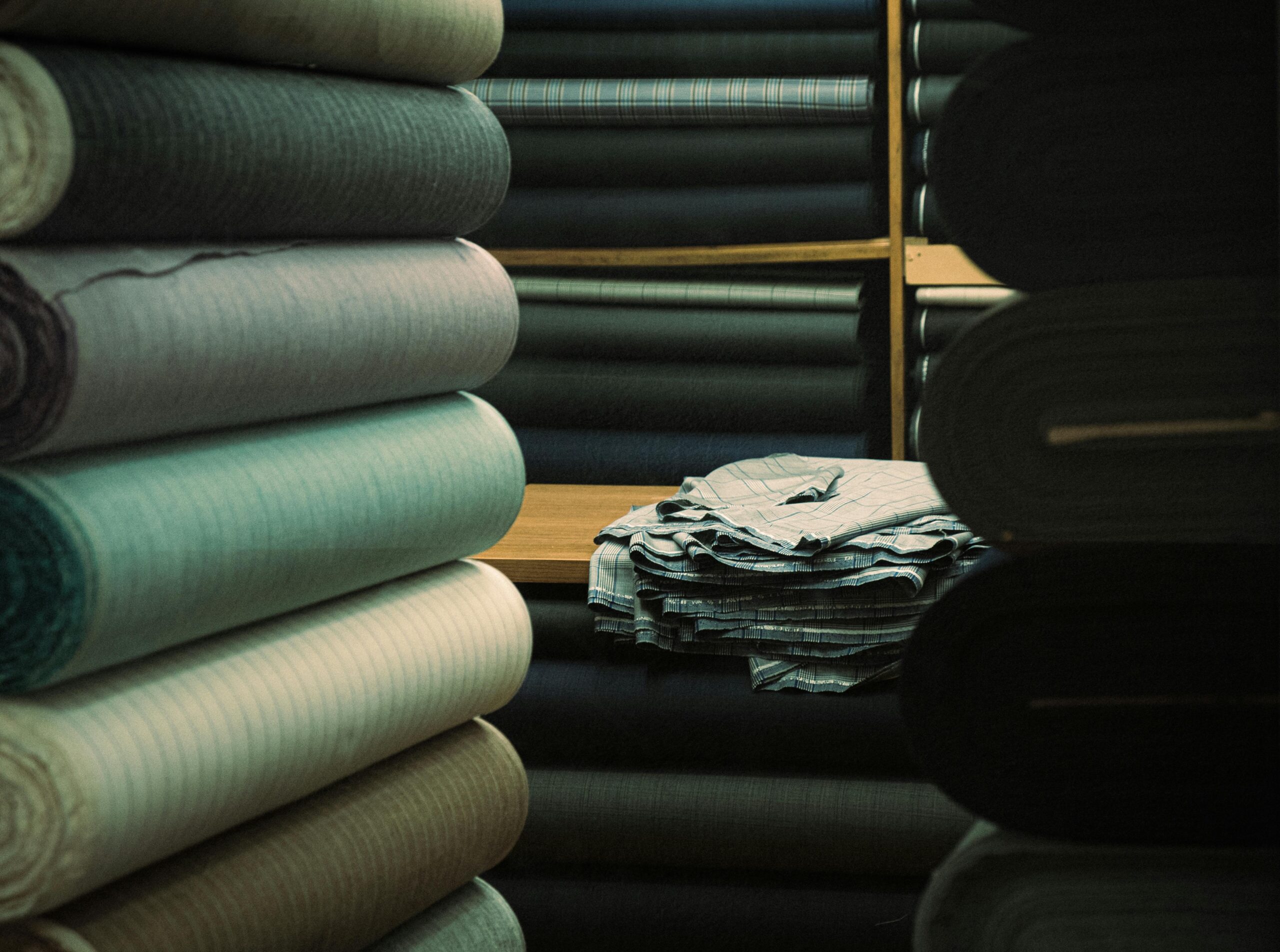 A variety of textile rolls on display in an İstanbul warehouse, showcasing fabric textures.